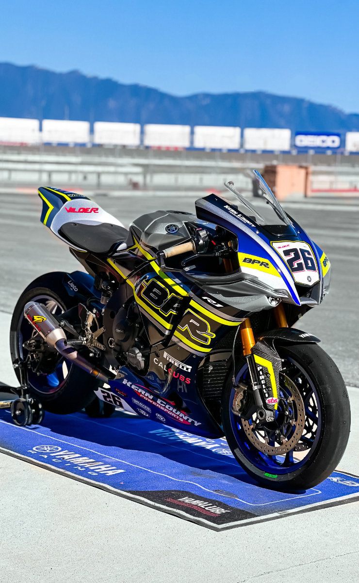 BRP racing motorcycle parked on a custom mat