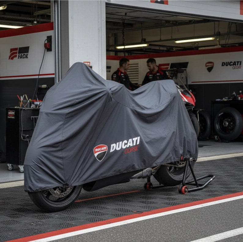Ducati Panigale V4 motorcycle cover with the Ducati logo printed on the side, draped over a motorcycle inside a garage setting.